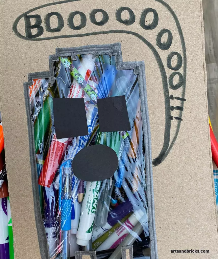 Our Ghost Peek-A-Boo Cardboard Craft was especially created for a LEGO lovin' eight-year-old. We recycled our cereal boxes for the cardboard and used construction paper and plastic wrap. Our ghost cut-out is a Lego brick ghost! This craft encourages kids to explore the vast amount of colors and textures that surround them. Bonus for older kids: this projects starts to teach how to frame a composition, too.#ghost #craft #forkids #autumn #halloween #lego 