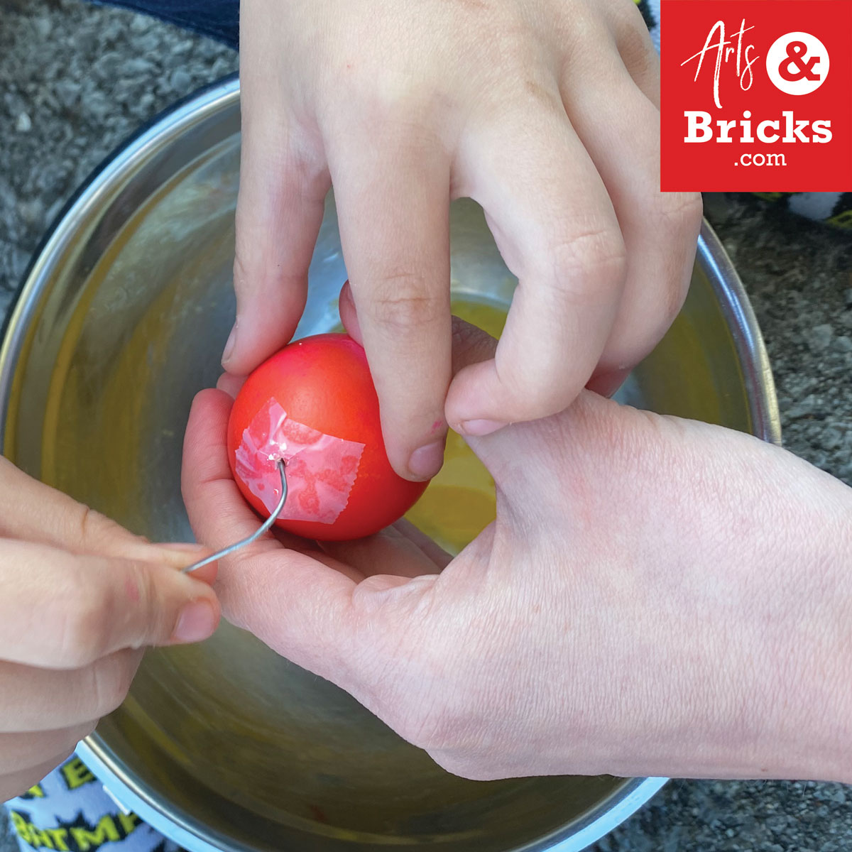 Use a paper clip to break up the yolk in prep for blowing out your easter egg.