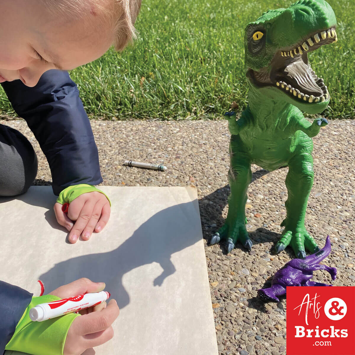 Trace your toys, like a dinosaur, in the afternoon sun. Simple get outside art craft for kids.