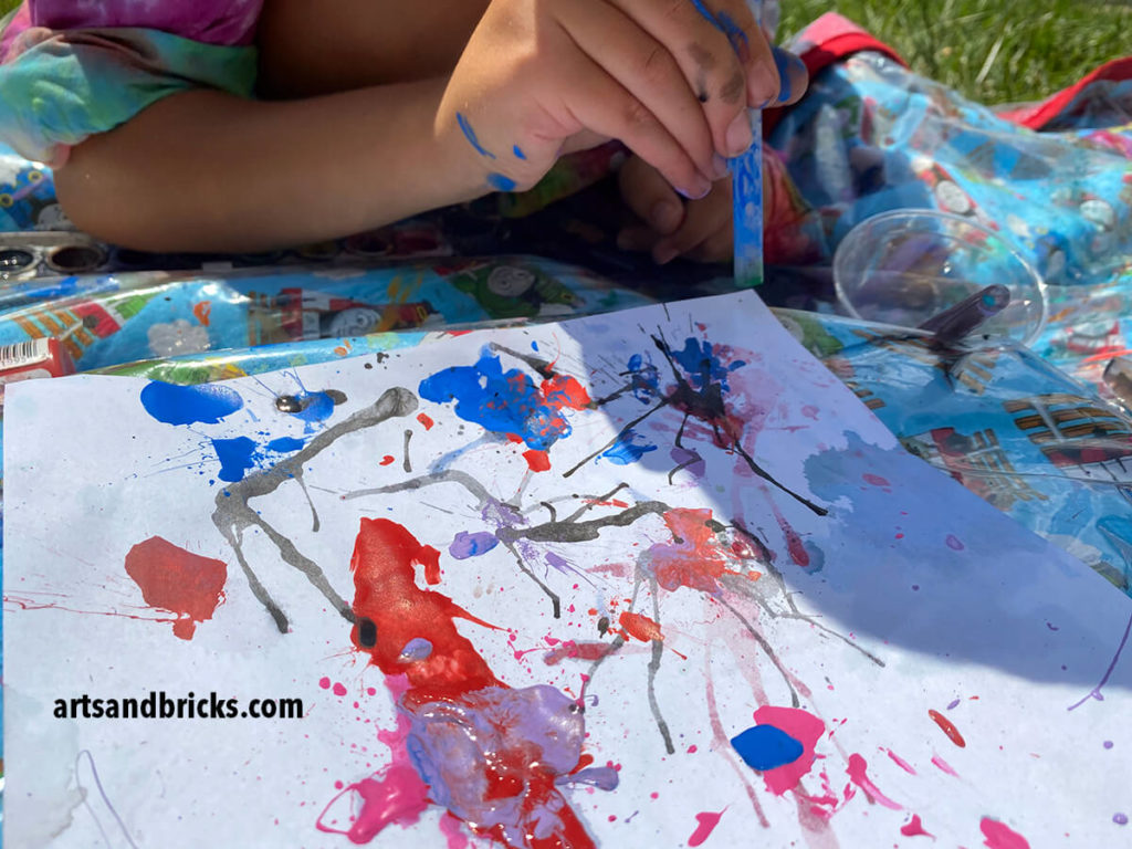 Blow water color paint with a straw to make abstract art with kids