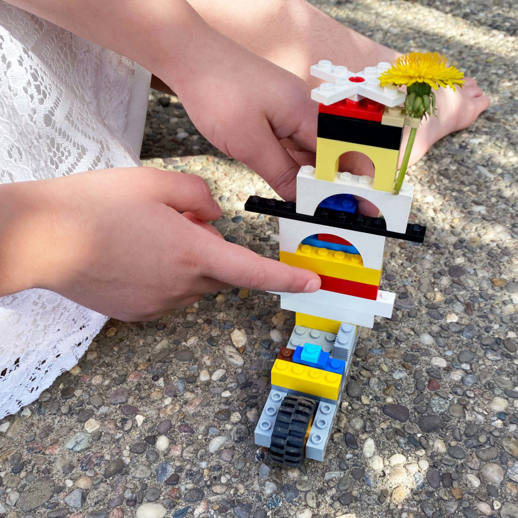 Use a LEGO brick with a hook to hold flowers - perfect for your summer and spring MOCs. Shown with a dandelion!