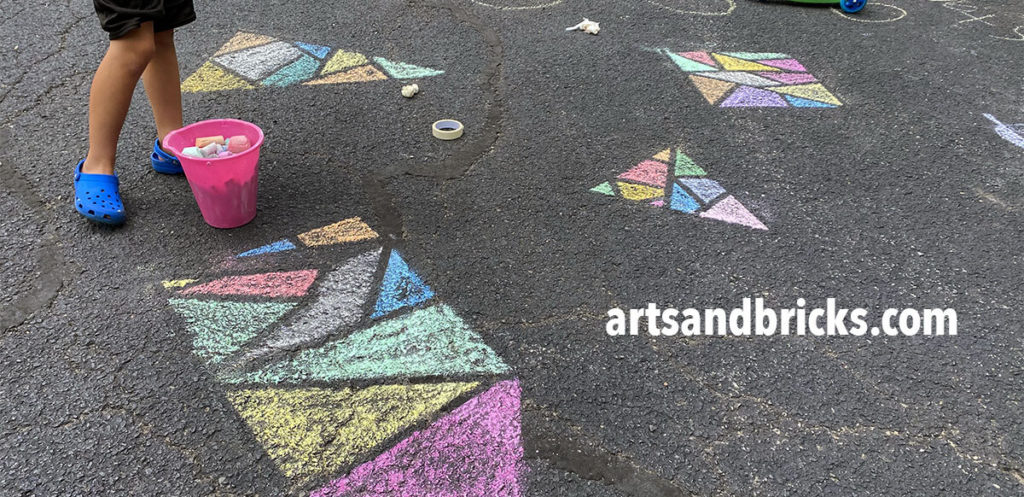 One of my favorite things about outdoor chalk art projects is they allow kids to play with SCALE! Designs are not confined to small paper shapes but instead, designs can span entire driveways. The ability to fully move around a design and to create art as large or small as you choose is VERY FREEING!