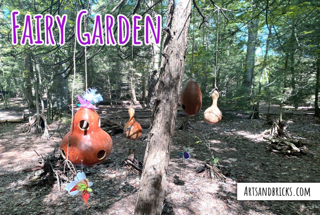 Examples of fairy garden gourd homes at a botanic garden.