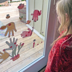 Handprint art turned into wall decals and window cling for play