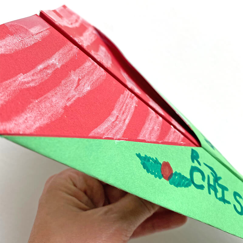 Find inspiration for a Christmas-themed paper airplane! Candy-cane striping, holly berries and lots of Christmas Cheer! We used card stock, tape, staples, markers and crayons!