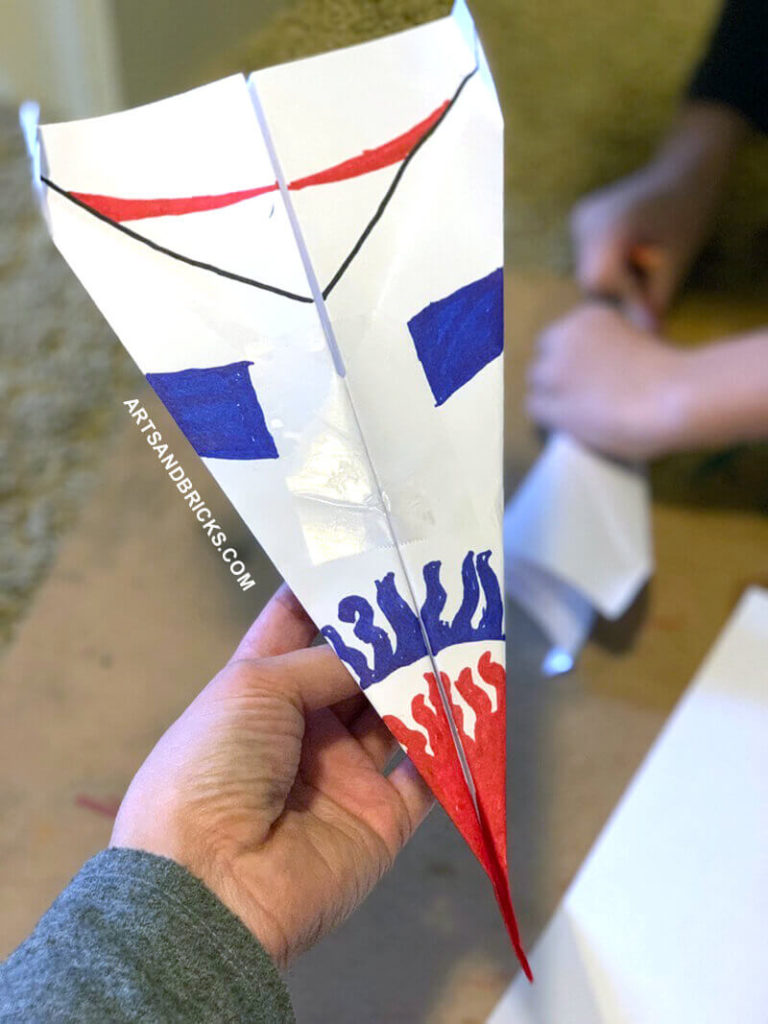 Simple paper airplanes are a fun way to pass time with your kiddos. Encourage creative designs - like patriotic flames!