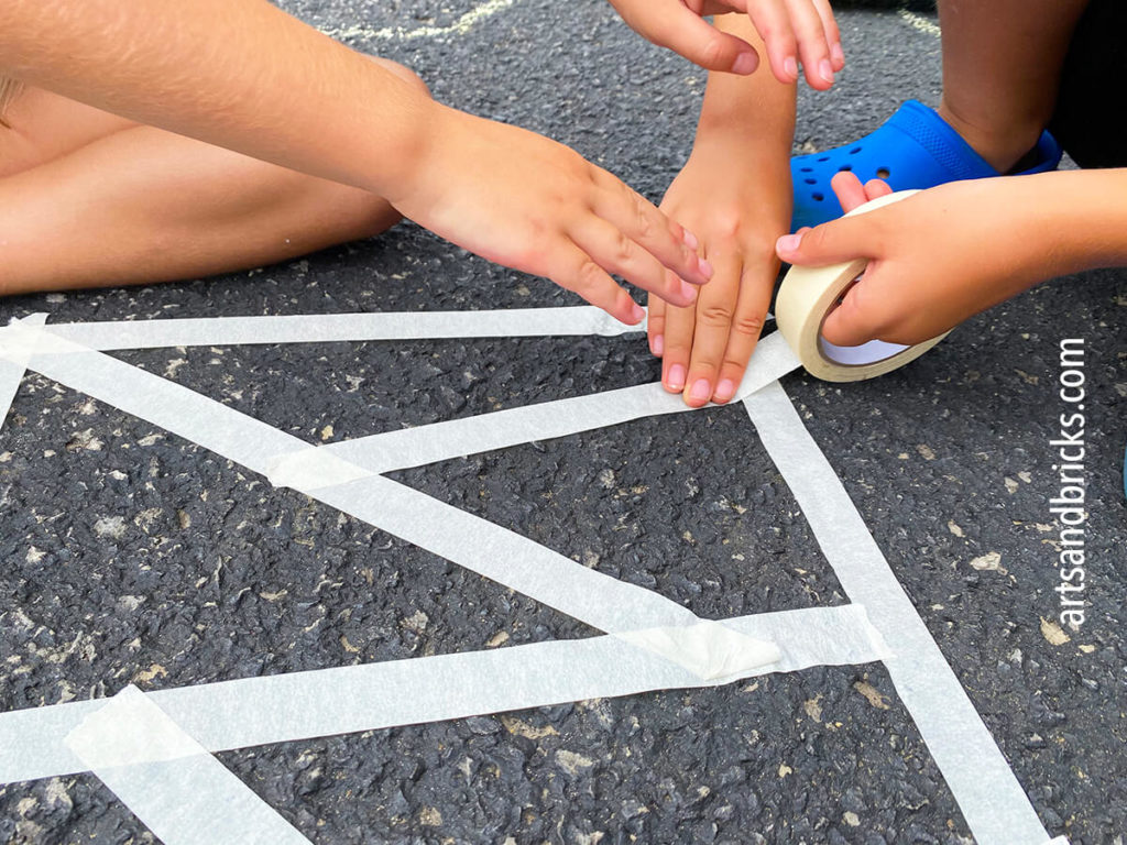 What type of tape should I use for chalk mosaic art with kids? For chalk mosaic art, you can use any tape that will stick sufficiently to your pavement, cement, or driveway. Masking tape is a cheap option and is what we used because we had it on hand at home, but you can also use painter's tape, electric tape, or even duct tape. Some mommas have shared that especially in very hot weather, too strong of tape will become quite difficult to remove. 