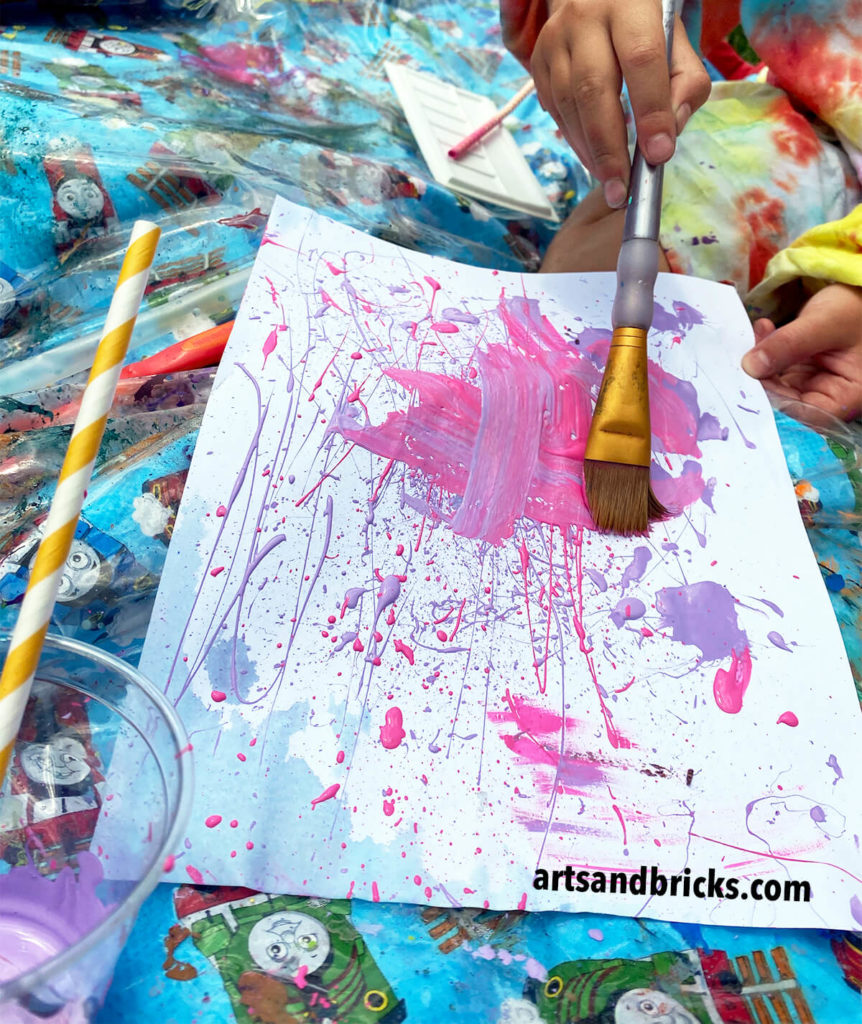 Experimental painting with straws and brushes sparks children's imaginations and lets them create freely - exploring the medium without fears of creating anything realistic.