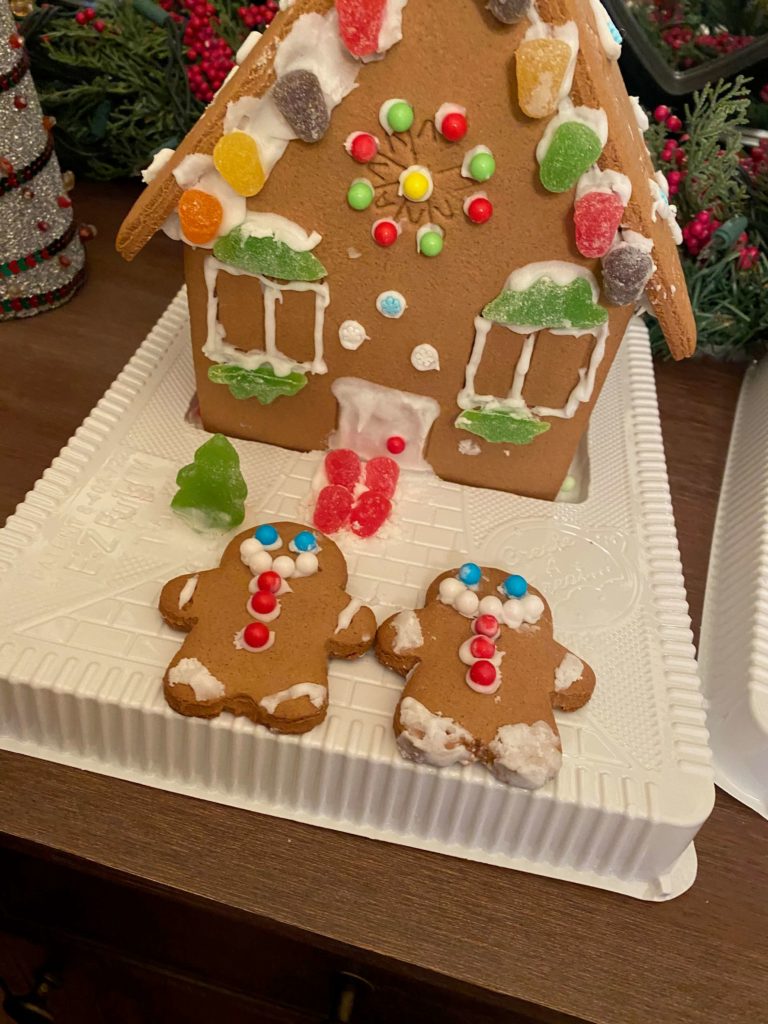 The Gingerbread House with E-Z-Build Roof Holder includes two gingerbread people and lots of candy for decoarting.