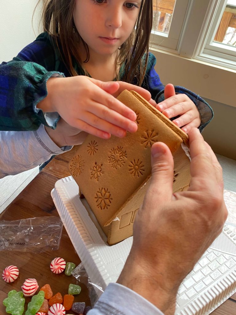 Gingerbread house building is a great yearly holiday tradition and fun way to spend time with your kids!