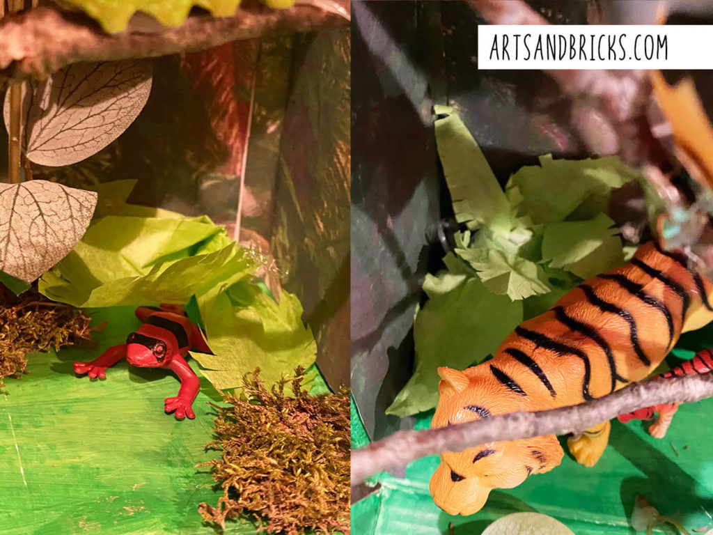 For this jungle rainforest diorama, we followed instructions we found online to make a couple of tropical plants from green tissue paper. We accordion folder the paper and then cut patterns into the paper. The results are giant leafy ferns. They look great. 