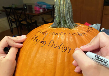 Writing joys on a gratitude pumpkin